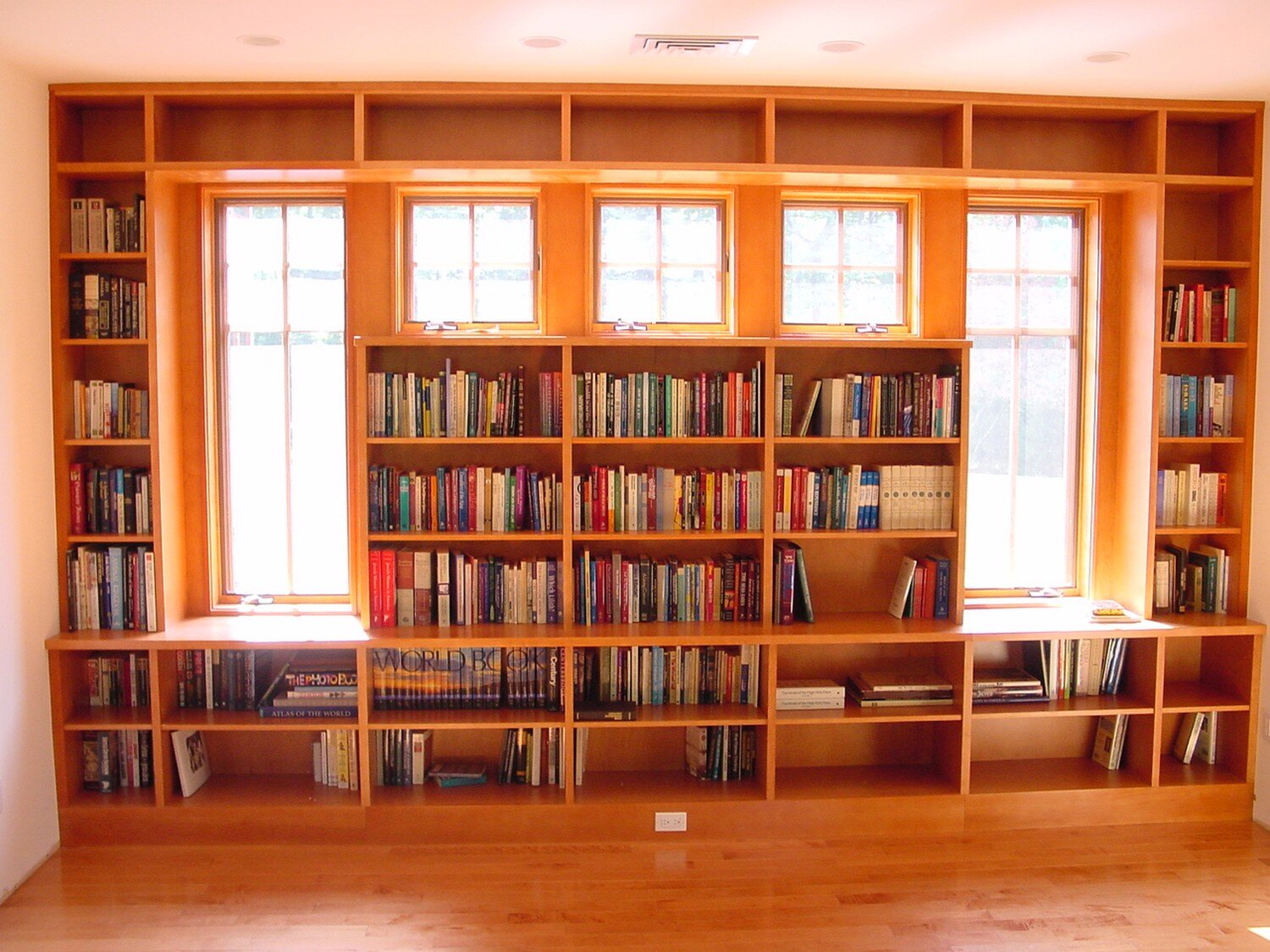 Built-in wood library with windows and shelving in a Westchester interior